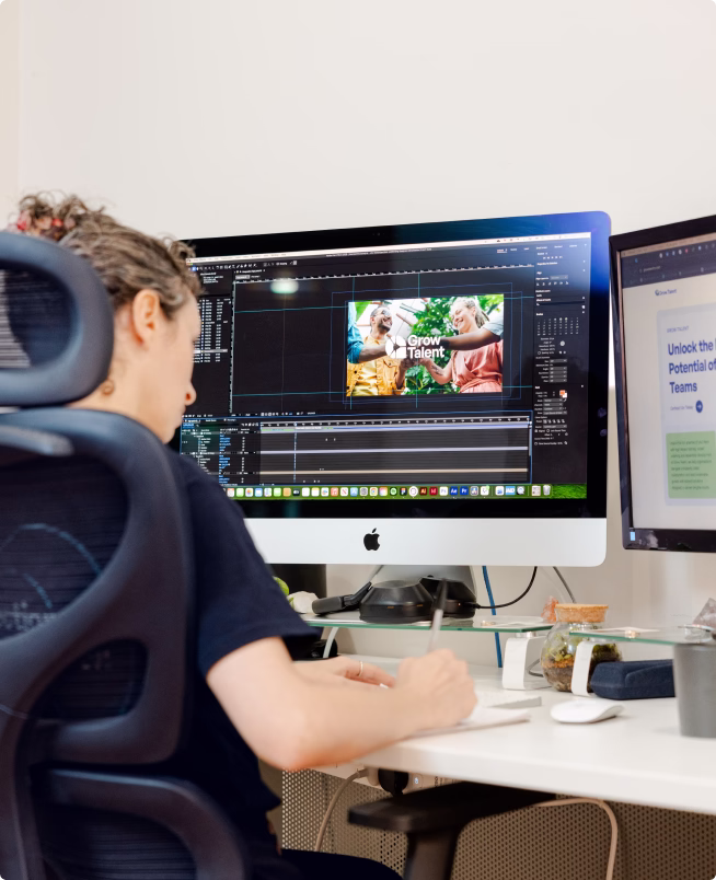 Optimise Online designer editing a Grow Talent video on a multi-monitor setup